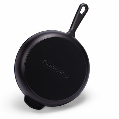 Black enameled cast iron skillet by BUCHYMIX NIGERIA, showing a smooth, glossy surface and sturdy handle.