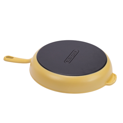Yellow enameled cast iron skillet by BUCHYMIX NIGERIA, showcasing a smooth, durable cooking surface and sturdy handle.